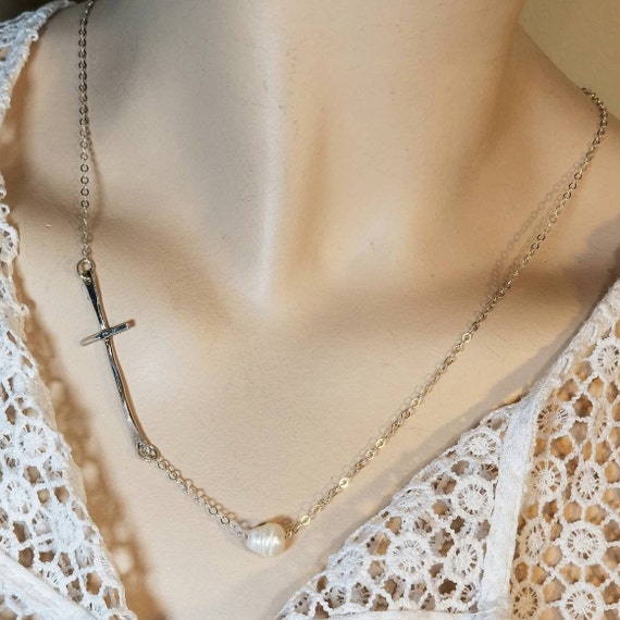Sterling silver cross pendant with pearl center