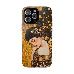 May include: A phone case with a painting of a woman with long dark hair and a gold background. The woman is wearing a gold necklace and earrings. The phone case has a black border.