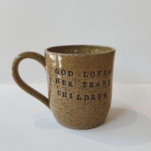God Loves Her Trans Children Mug – Handmade Queer Pottery Coffee Cup | LGBTQ+ Gift, Pride Mug, Faith Holiday Gift Idea