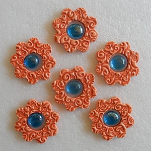FLOWERS...6 handmade embossed ceramic mosaic tiles...kiln fired stoneware clay (poppy glaze) with 6 blue flat back glass gem centers)