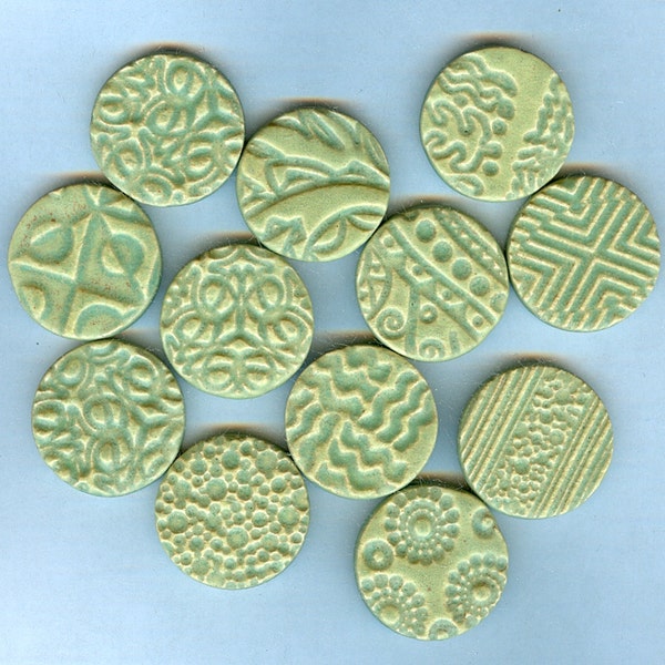 2 dollars off..............handmade embossed round tiles with matte green glaze