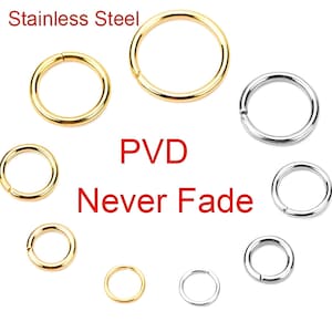 May include: An assortment of gold and silver stainless steel circular rings. The text "Stainless Steel", "PVD", and "Never Fade" are displayed in red and white. The rings are in various sizes and are open, with a small gap.