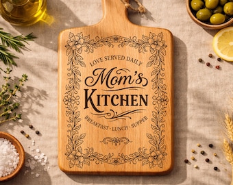 May include: Wooden chopping board with the text "Mom's Kitchen" and a floral border. The board is surrounded by ingredients like olives, lemons, herbs, and spices. The text includes "Love Served Daily" and meal times.