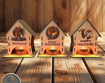 May include: Three wooden candle holders with a Halloween theme. Each holder features a different design: a witch, a cat, and a spooky tree. The holders are lit with candles, creating a warm glow.