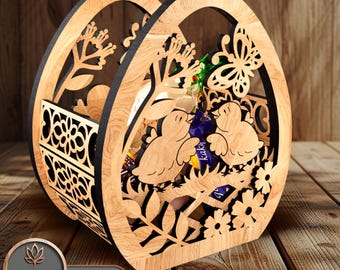 May include: Wooden Easter egg basket featuring a cut-out design of birds, butterflies, and flowers. The basket has a handle and is ideal for holding small gifts or treats.