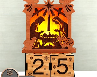 May include: Laser-cut wooden Christmas nativity scene. The design includes angels, a star, and the figures of Mary, Joseph, and baby Jesus. The base shows the numbers "25" with snowflake and star details. The text "LASER BUILD.LAB TEMPLATE LASER CUT" is visible.