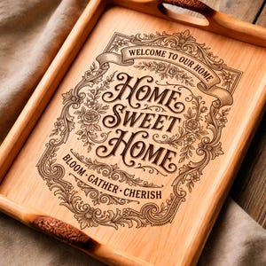 Op de afbeelding: Houten dienblad met gesneden handgrepen. De lade toont de woorden "Home Sweet Home" in een sierlijk ontwerp, omgeven door bloemen en krullen. De tekst "Welcome to our Home" en "Bloom, Gather, Cherish" zijn ook opgenomen.