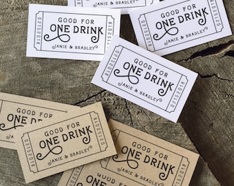 May include: A set of eight brown paper drink tickets with the text "Good for One Drink" and "Janie & Bradley" printed in black. The tickets are designed to look like old-fashioned paper tickets.
