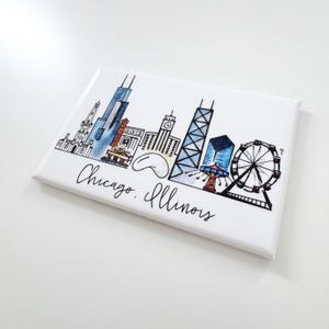 May include: A white magnet with a black and white illustration of the Chicago skyline. The skyline includes the Willis Tower, the John Hancock Center, the Wrigley Building, and the Navy Pier Ferris wheel. The text "Chicago, Illinois" is written below the skyline.
