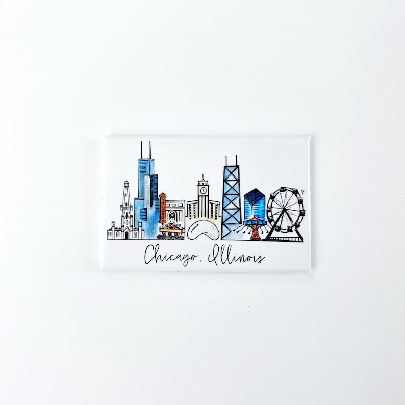 May include: A white magnet with a hand-drawn illustration of the Chicago skyline. The skyline includes the Willis Tower, the John Hancock Center, the Wrigley Building, the Chicago River, and the Navy Pier Ferris wheel. The text "Chicago, Illinois" is written below the skyline.