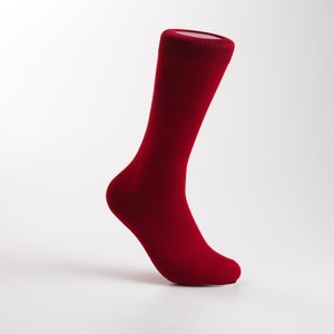 May include: A single red sock with a ribbed top, shown on a white background.