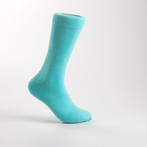 May include: A single turquoise blue sock is displayed on a white background. The sock is made of a soft, comfortable material and is perfect for everyday wear.