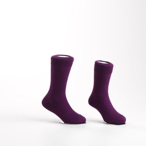 May include: Two pairs of purple socks on a white background. The socks are made of a soft, comfortable material and are perfect for everyday wear.