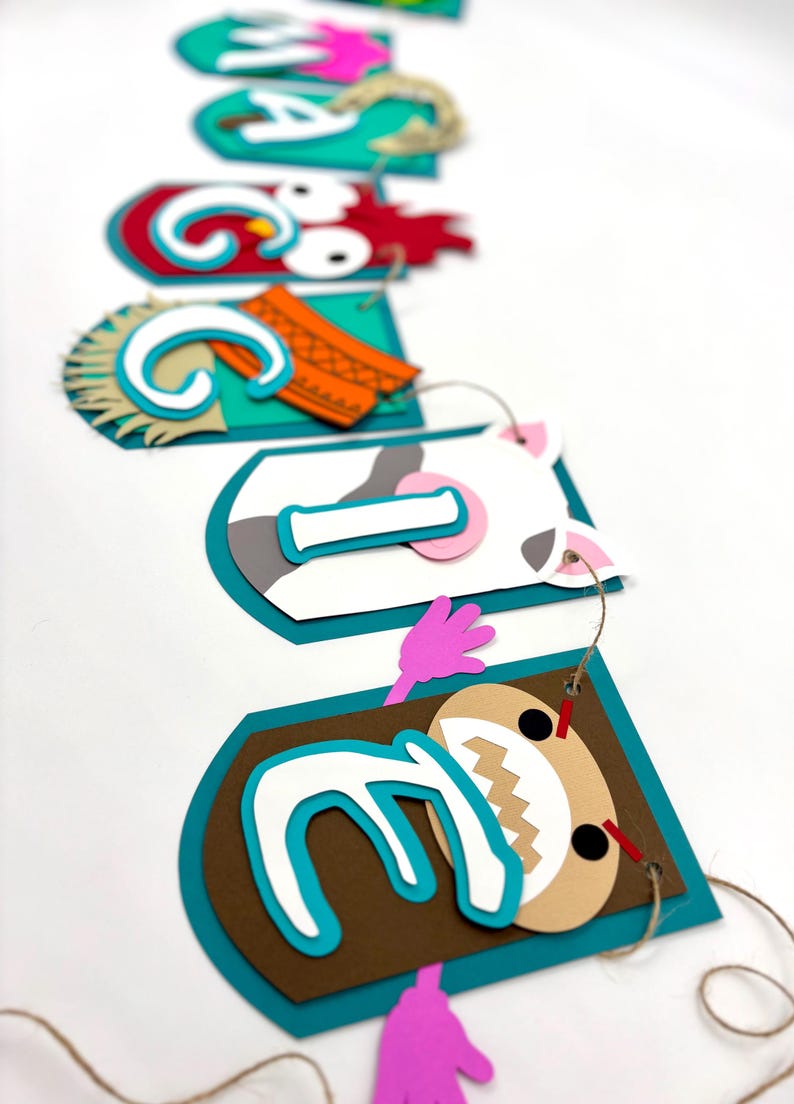 May include: A colourful paper banner with animal characters and the letters "G I Z E L L E" in white letters on a turquoise background. The characters include a rooster, a cow, a pig, and a monster.