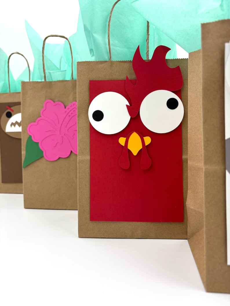 May include: Brown paper gift bags with decorative cutouts. One bag features a red rooster design with white eyes and a yellow beak. Other bags have a pink flower and a bear face. Each bag has a brown handle and is filled with teal tissue paper.