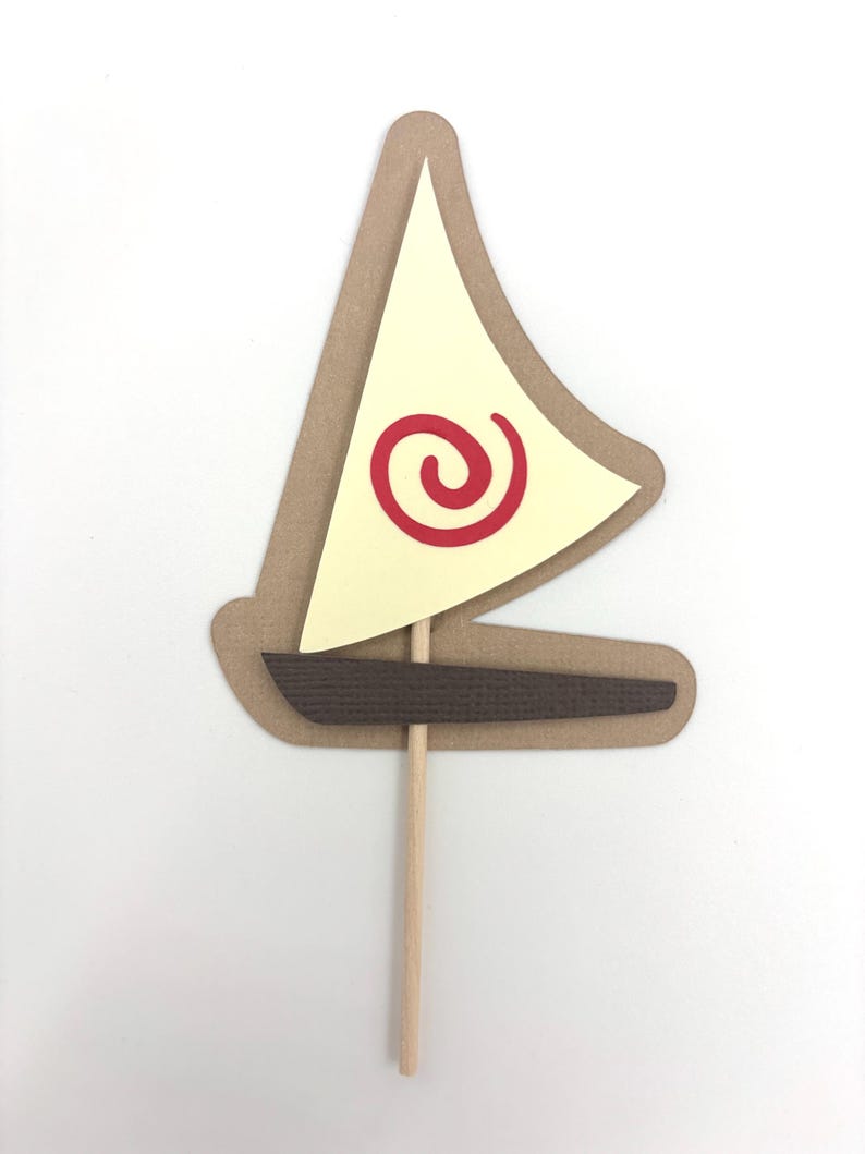 May include: A brown paper sailboat with a yellow sail and a red spiral design. The sailboat is attached to a wooden stick.