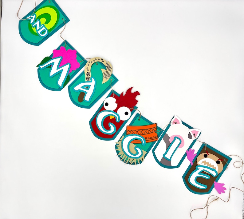 May include: A teal blue banner with the name "Maggie" spelled out in white letters. Each letter is decorated with a different character from the film Moana, including a rooster, a pig, and a crab.