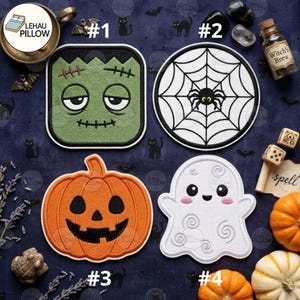 May include: Four embroidered patches featuring Halloween designs: a square green monster face, a round spider web with a spider, an orange pumpkin jack-o'-lantern, and a white ghost with pink cheeks. Each patch has a thick black border.