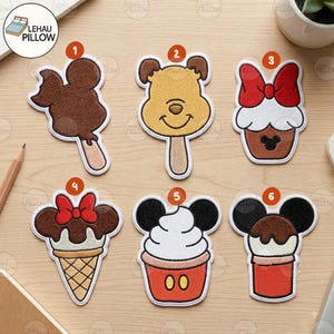 May include: Six embroidered patches featuring cartoon-inspired food designs. Number 1 is a brown ice cream bar, 2 is a yellow bear-shaped popsicle, 3 is a cupcake with a red bow, 4 is an ice cream cone with a red bow, 5 is a sundae, and 6 is a dessert.