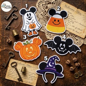 May include: Five embroidered Halloween-themed patches featuring Mickey Mouse ears: a ghost holding a pumpkin bucket, a candy corn, a pumpkin, a bat, and a purple witch hat with stars and a crescent moon. Each patch has a white border.