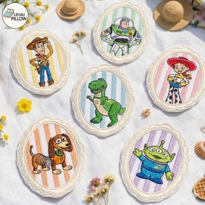 May include: Six oval embroidered patches featuring Toy Story characters: Woody on yellow stripes, Buzz Lightyear on green stripes, Jessie on pink stripes, Rex on blue stripes, Slinky Dog on orange stripes, and an Alien on purple stripes.