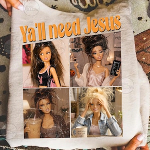 May include: A light gray sweatshirt featuring the orange text Ya'll need Jesus and four photographic panels of dolls. The images show dolls with long brown hair in various outfits, including a black top, a pink camisole, and a denim jacket.