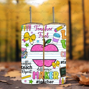 May include: A stainless steel tumbler with a straw, featuring a colorful design for teachers. The design includes an apple, pencils, coffee cup, and the words "Teacher Fuel" and "Maker". The tumbler is decorated with various school-themed graphics.