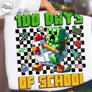 May include: White pillow with a colorful graphic celebrating "100 Days Of School." The design features pixelated characters, a chicken, a green block character, and school-themed icons against a black and white checkered background.