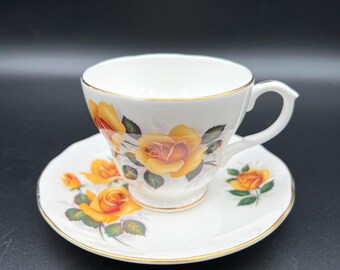 Vintage Dutchess Bone China England Yellow Roses Green Leaves Gold Rim Footed Tea Cup And Saucer