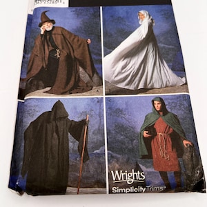 May include: A sewing pattern envelope for hooded cloaks and robes featuring four variations: a brown robe with a pointed hat, a white hooded cloak, a black hooded robe with a wooden staff, and a green hooded cloak worn over a red tunic with a rope belt.