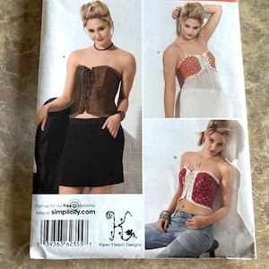 May include: A sewing pattern featuring three different corset designs. The main image shows a woman wearing a brown corset with a black skirt. The pattern includes instructions for a strapless corset, a lace-up corset, and a corset top with spaghetti straps.