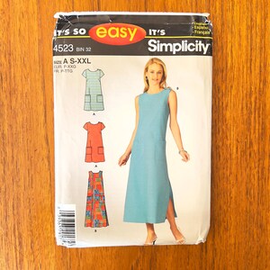May include: A Simplicity sewing pattern envelope, number 4523, labeled It's So Easy. The package displays illustrations of a sleeveless, knee-length dress with side pockets in green plaid, solid orange, and a colorful patterned fabric.