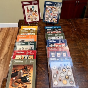May include: A collection of sixteen hardcover books titled The Encyclopedia of Collectibles, arranged in two columns. Each book cover features a unique photographic collage of various antique items, including glassware, pocket watches, and tools.