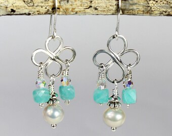 May include: Silver earrings with a clover design, featuring turquoise and crystal beads, and a pearl drop.