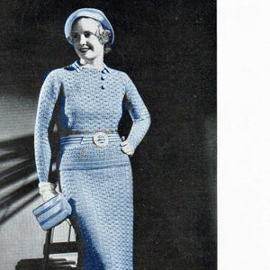 May include: A vintage image of a light blue crocheted ensemble, including a long-sleeved top, a skirt, and a matching hat. The outfit is accessorized with a belt and a small purse. The text "CROCHETED ENSEMBLE" is at the bottom.