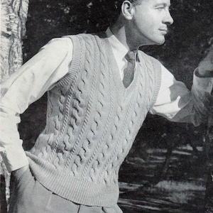 May include: A light gray cable-knit vest with a V-neck. The vest is worn over a white collared shirt and a patterned tie. The image is in black and white.