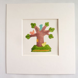 May include: A framed print of a colorful illustration of a tree with birds. The tree has a brown trunk and green leaves. The birds are red, yellow, and blue. The print is titled "The Little Forest".