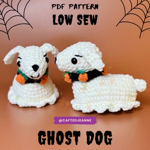 May include: Two crocheted ghost dog amigurumi toys with black and orange accents. The toys are sitting on a brown surface with a spiderweb pattern in the background. The text "PDF PATTERN LOW SEW" and "GHOST DOG" are visible in the image.