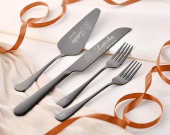 May include: A set of three black metal utensils for a wedding cake. The cake knife and server are engraved with the names "Latisha" and "2024.10.10". The forks are engraved with "&" and "&"