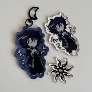 May include: A white ceramic mug with a black handle and the text "But First, Coffee" in a black, handwritten-style font. The mug is on a white surface.