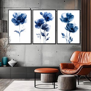 a living room filled with furniture and paintings on the wall