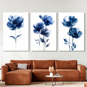a living room with a couch and two paintings on the wall