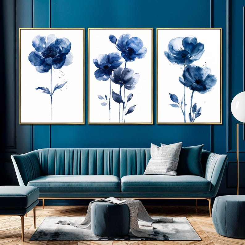 a living room with a couch and two paintings on the wall