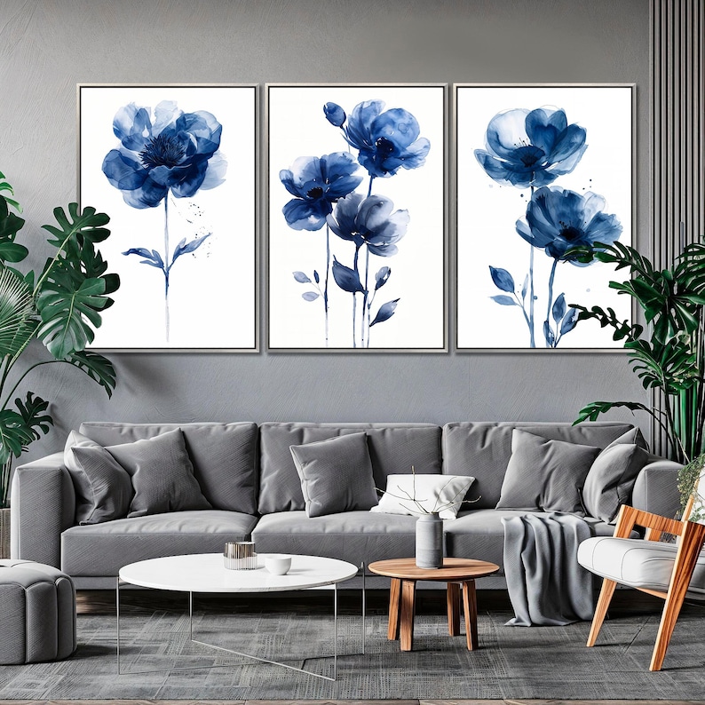 a living room filled with furniture and paintings on the wall