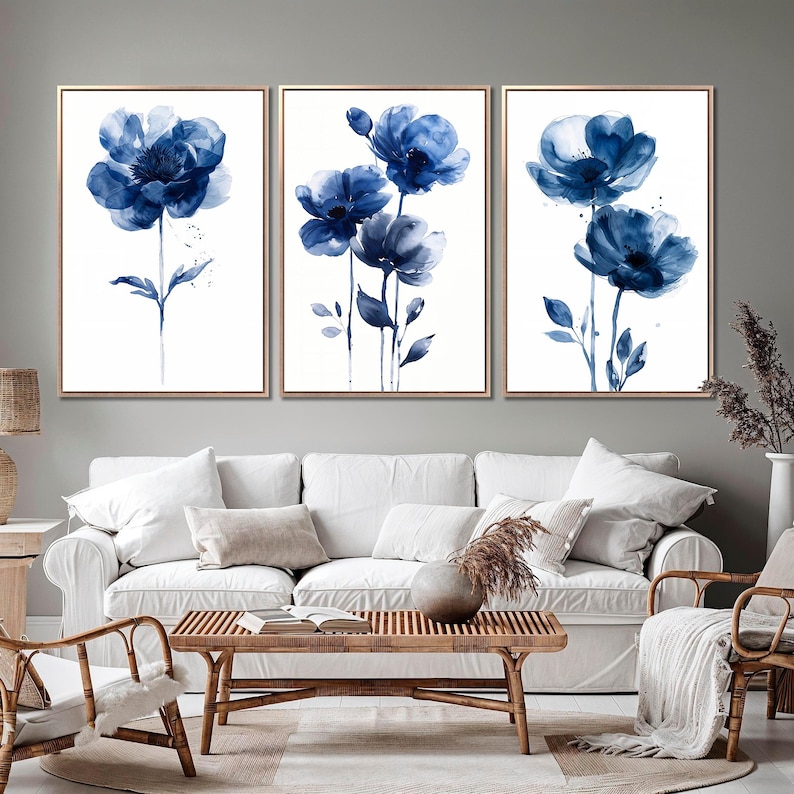 a living room filled with furniture and paintings on the wall