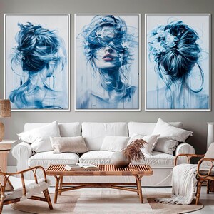 May include: Three abstract paintings of a woman with blue hair and flowers. The woman in the center painting has her eyes closed and flowers in her hair. The woman on the left is looking to the right and the woman on the right is looking to the left.