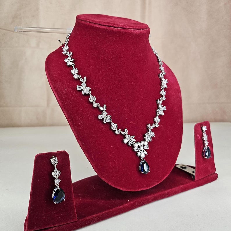 Blue Crystal Bridal Jewelry Set Teardrop Necklace and Earrings on model with long brown hair.