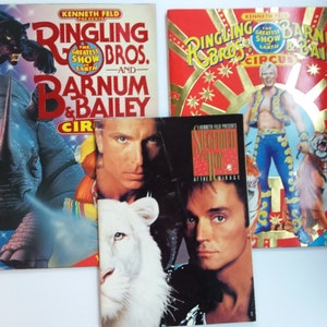 May include: Three vintage Ringling Bros. and Barnum & Bailey Circus programs and a Siegfried & Roy program. The circus programs feature images of a panther, rhino, and circus performers. The Siegfried & Roy program features the duo with a white tiger.