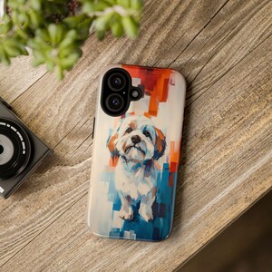 May include: A white dog with a colorful abstract background on a phone case. The case has a camera lens cutout.