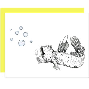 May include: A black and white line drawing of a fish blowing bubbles with a wand. The fish has a large mouth and fins. The bubbles are round and floating in the air.